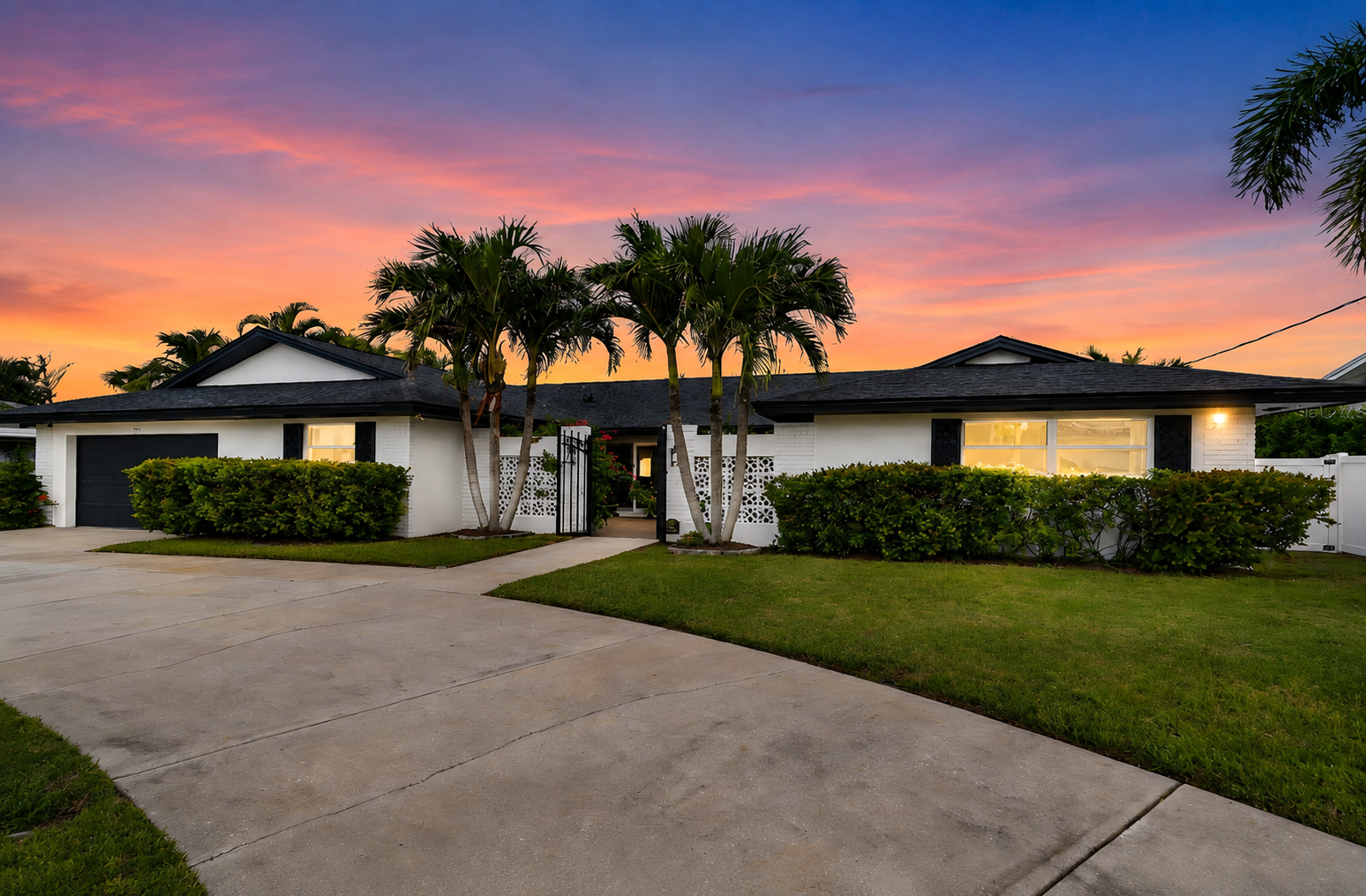 Distinctive rental home at dusk with a private pool overlooking the water