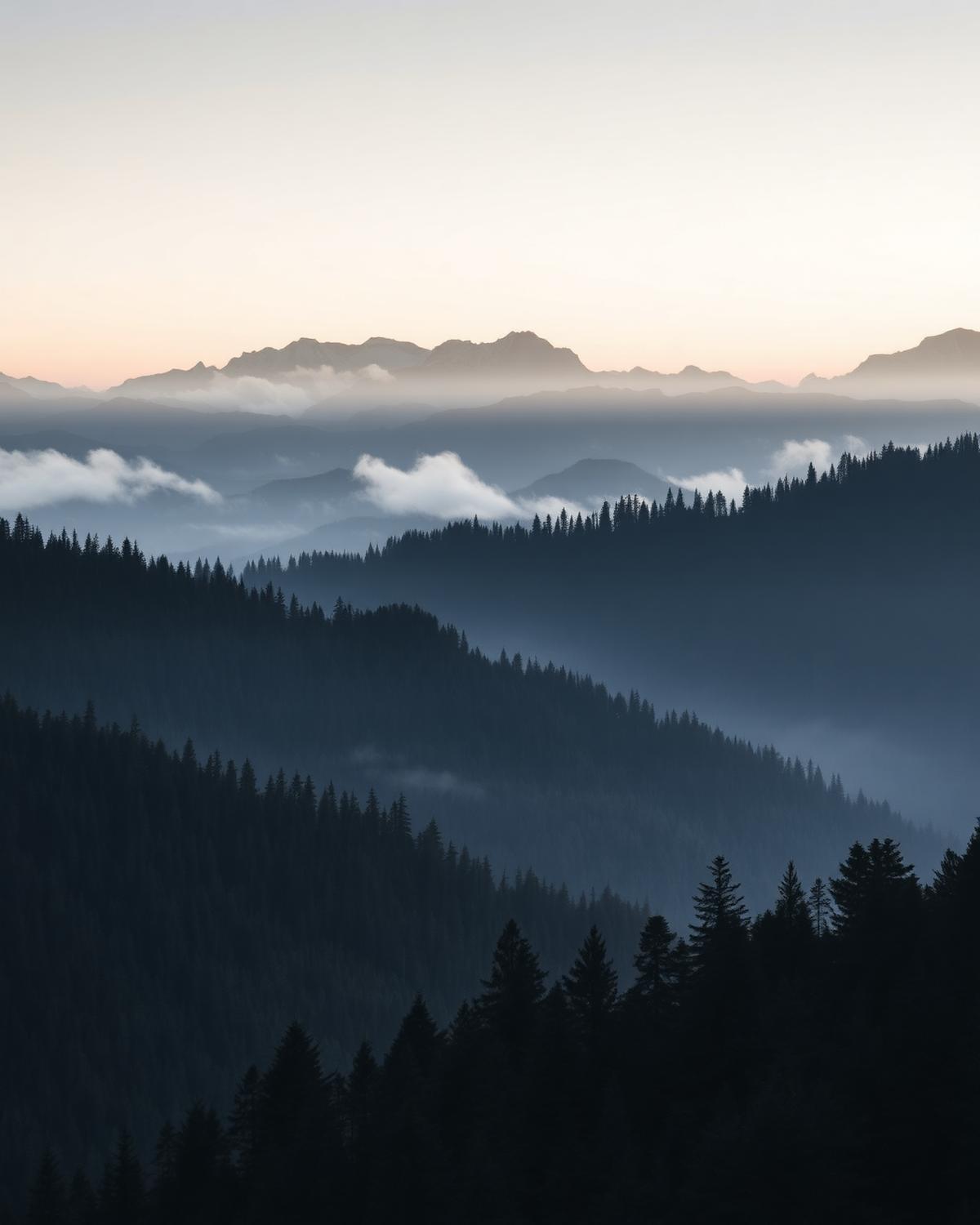 Layered mountain ridges in morning mist