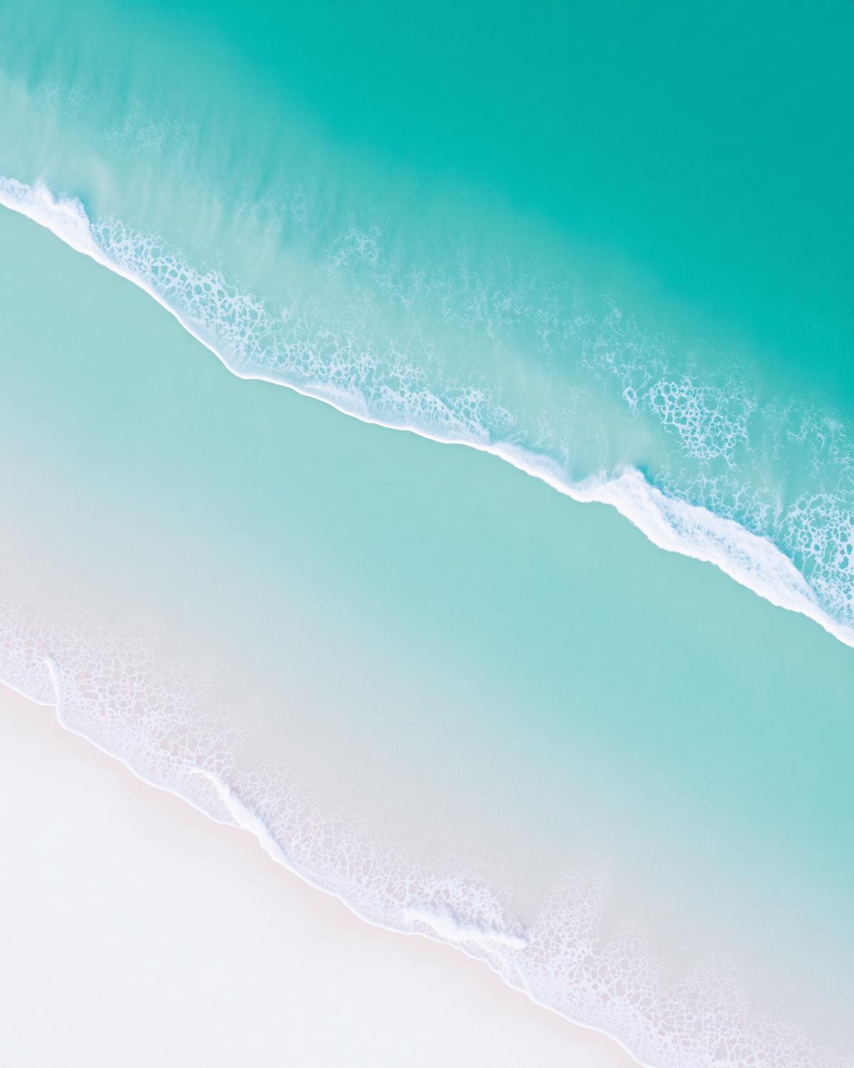 Turquoise ocean water meeting white sand